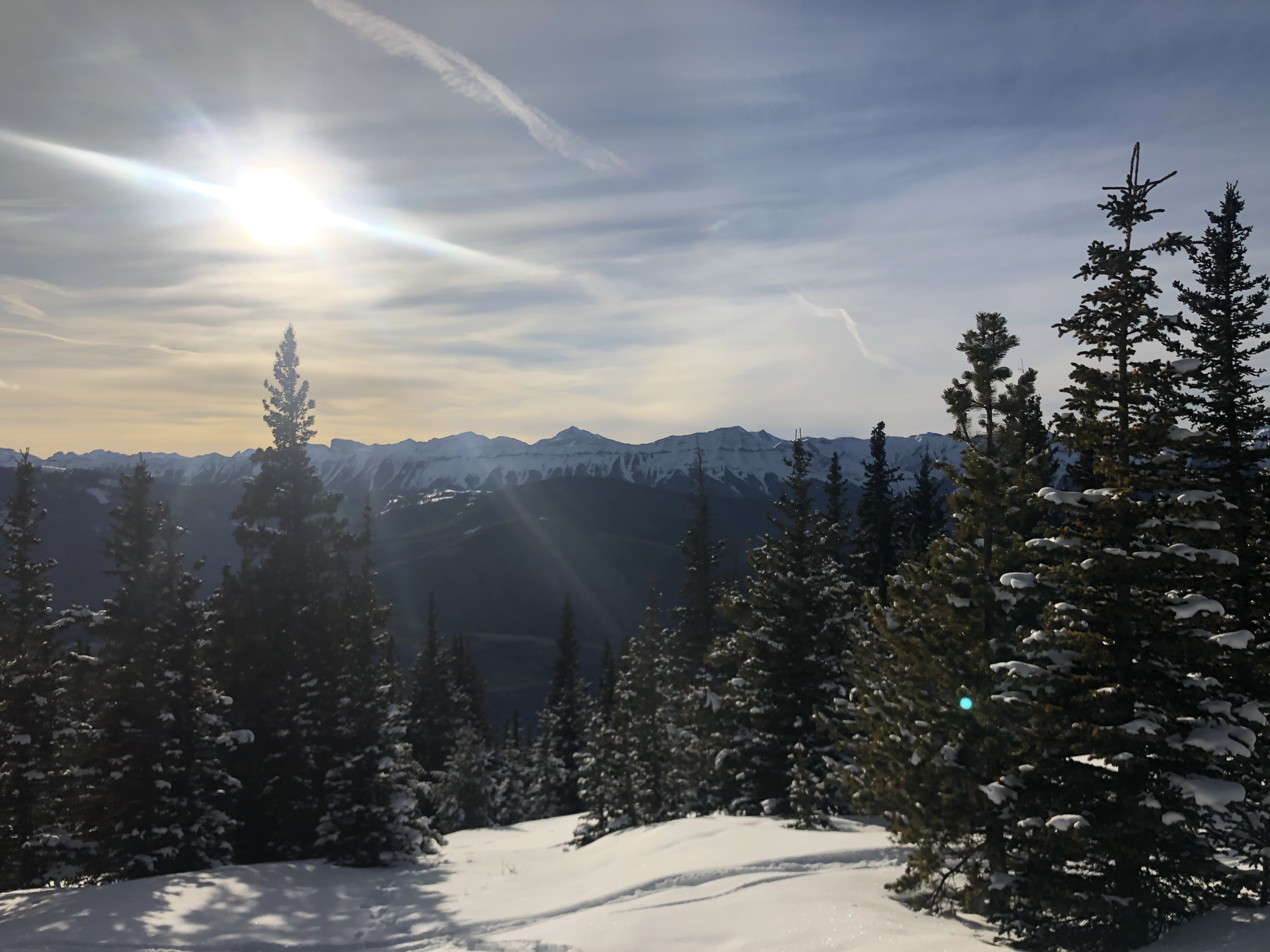 A hiker at a viewpoint looking over a river valley.