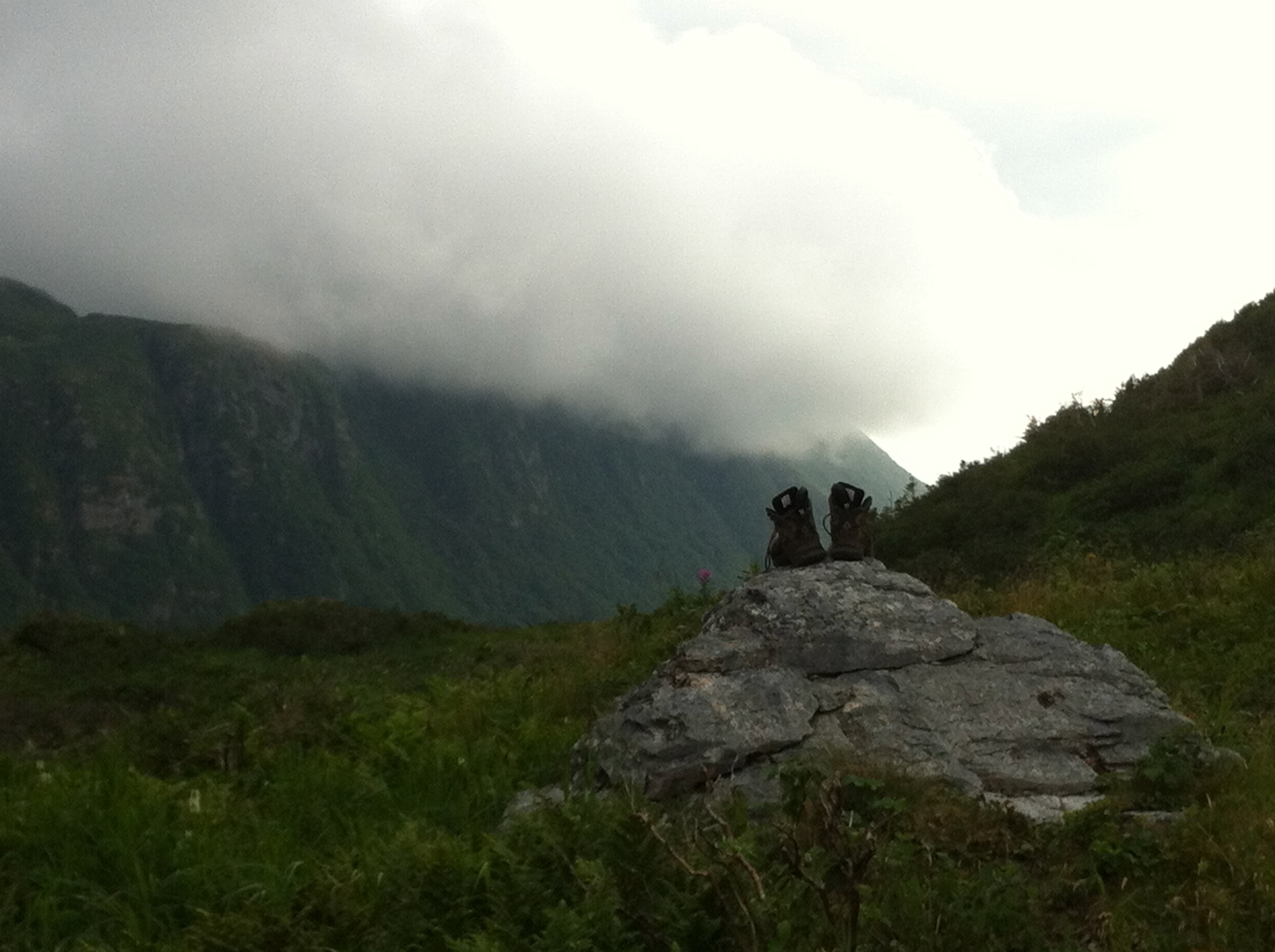 Hiking boots airing out on a rock during the Long Range Traverse.