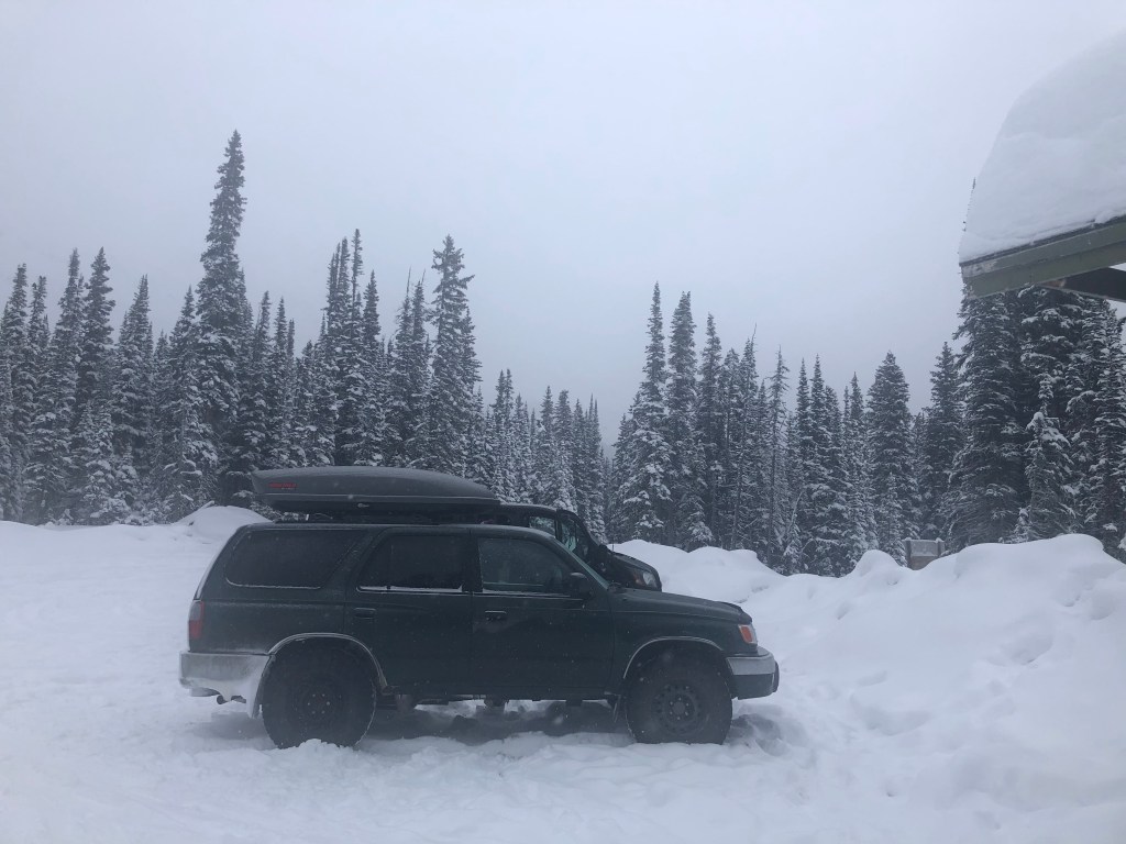 The 4Runner parked in the snow with a splitboard leaning against it.