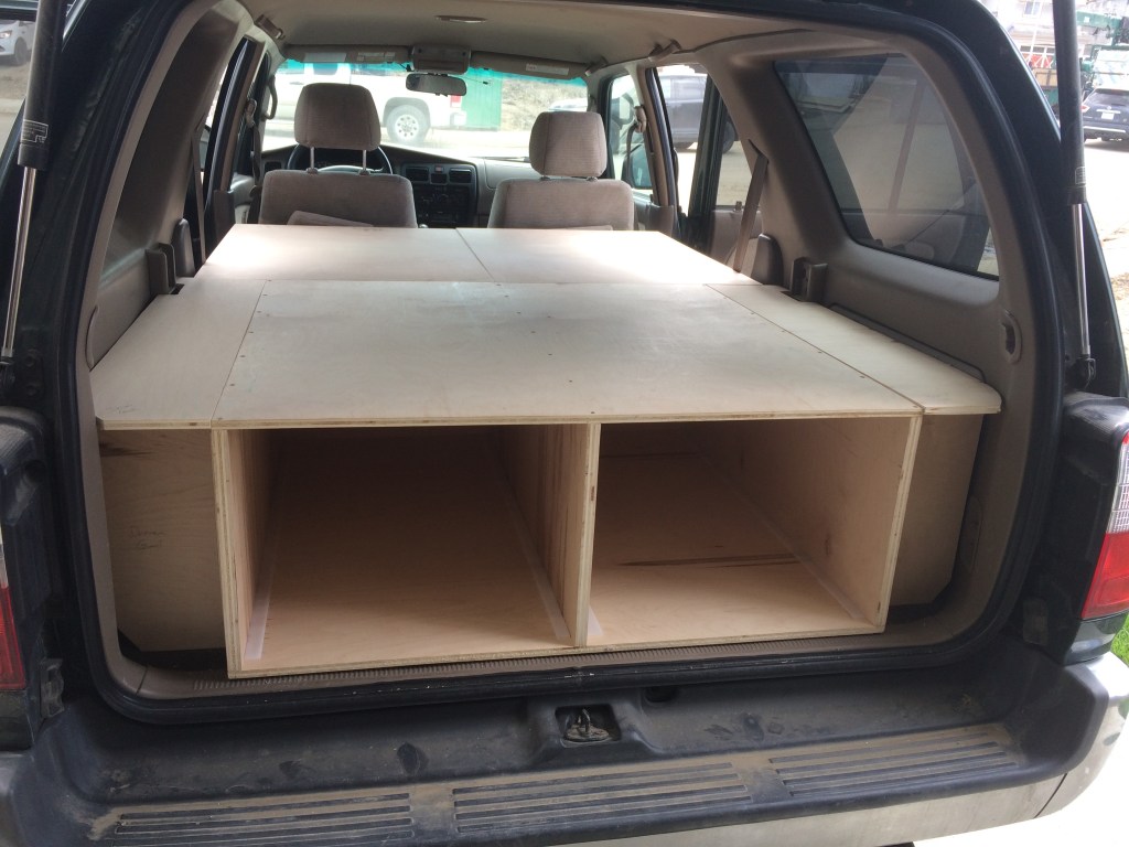 The completed wooden unit with side storage cubbies.